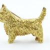 Een 18 kt geelgouden West Highland terrier , vervaardigd in Engeland. 16.7 gram 